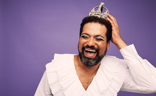 Cheerful drag queen with crown