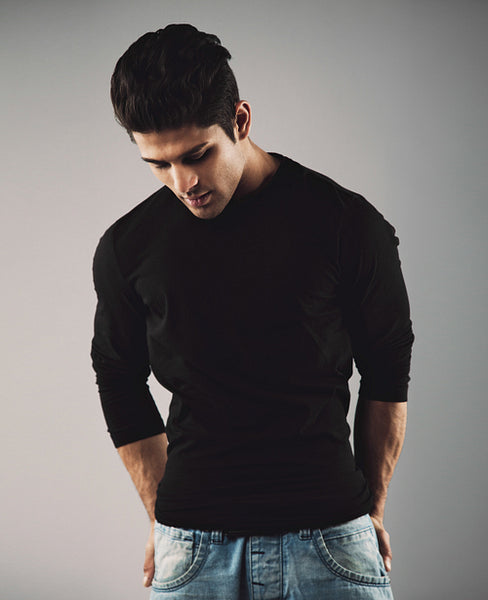 Thoughtful young guy on grey background.