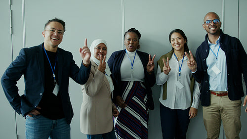 Diverse business professionals showing unity and happiness at a conference event