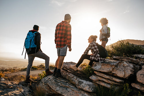 Group of hikers on top of hill and enjoying view