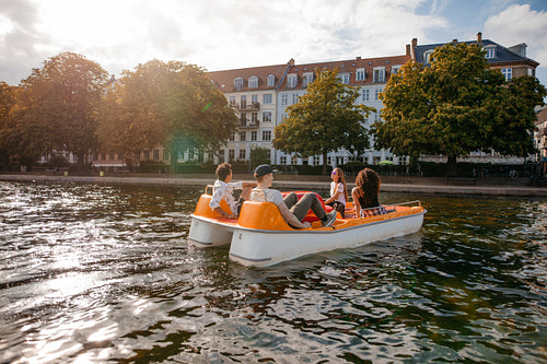 Young men and women boating in lake