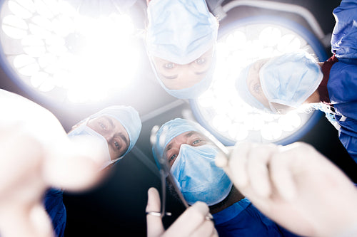 Surgeons operating under surgery lights