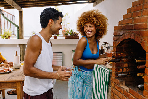 Friends enjoying a rooftop barbecue on a sunny day in Rio de Janeiro