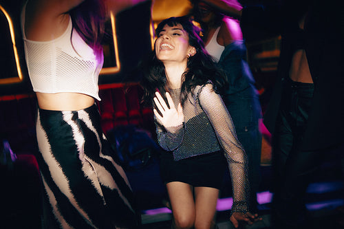 Group of friends enjoying a vibrant night out dancing in a club