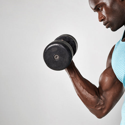 African man doing biceps curl with dumbbell