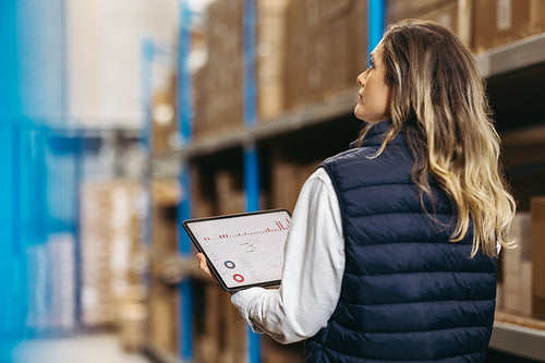 Warehouse manager using warehouse management software on a tablet