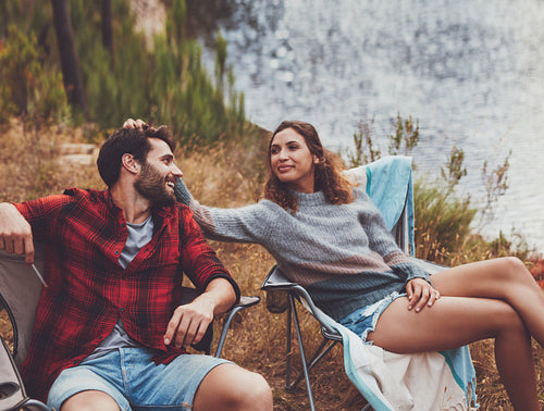 Affectionate young couple sitting at their campsite