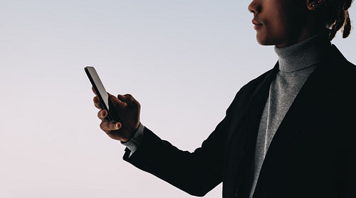 Connected man: Reading social media messages on stylish studio background