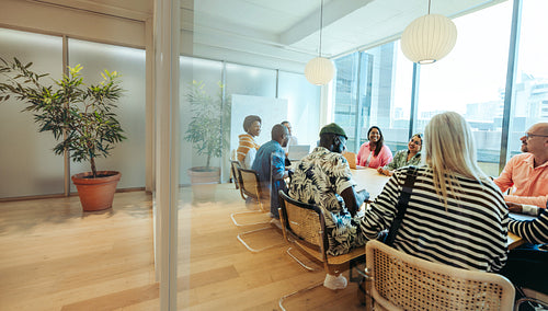 Pretty modern office space with diverse team meeting in a bright stylish studio