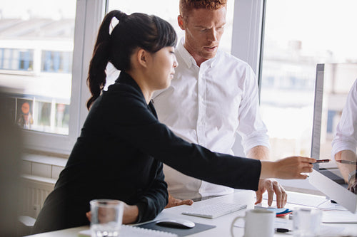 Business people working together on computer in office