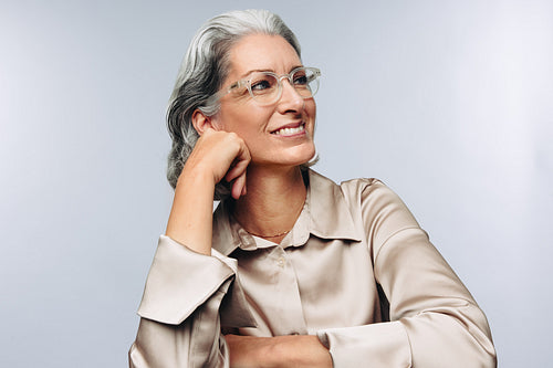 Woman resting chin on hand and smiling