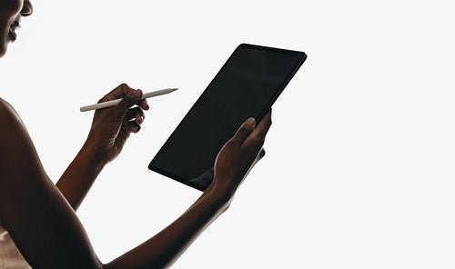 Person holding digital tablet and stylus for artistic creativity or productivity