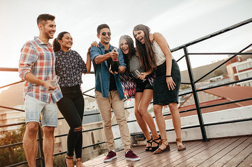 Young people having champagne at party.