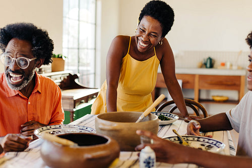 Brazilian family having a traditional feijoada meal together in home kitchen