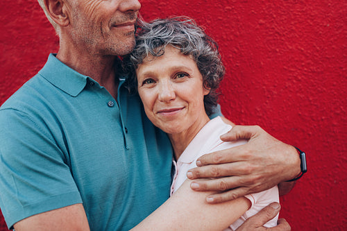 Happy mature woman embracing her husband