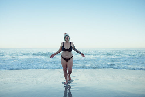 Woman having fun in the cold winter weather at the beach