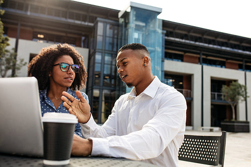 Business people discussing new project over laptop