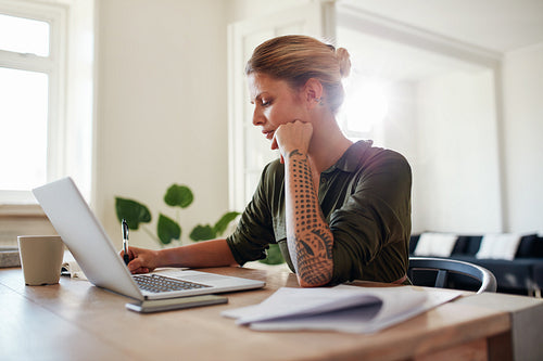 Young woman working at home office