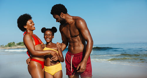 Happy family enjoying a sunny day at the beach together