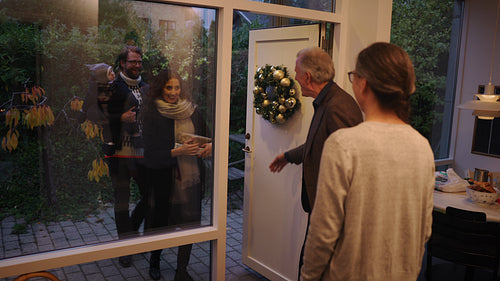 Family visiting grandparents for christmas dinner