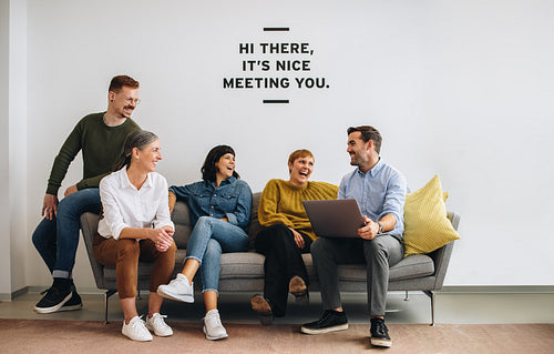 Happy entrepreneurs sitting together and sharing ideas