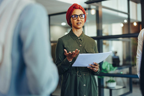 Confident businesswoman leading a meeting in an office