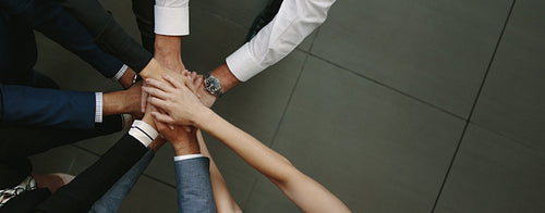 Business team putting hands together