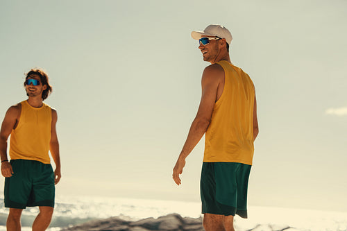 Smiling athletes enjoying a coastal game on a brazilian beach