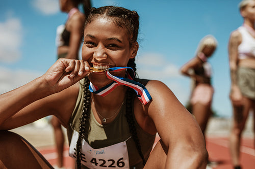 Runner looking excited after winning a medal