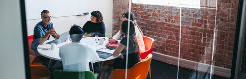 Supervisor briefing his colleagues in a meeting room
