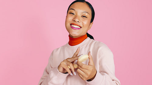 Fun with foundation: Woman applying cream foundation in a studio