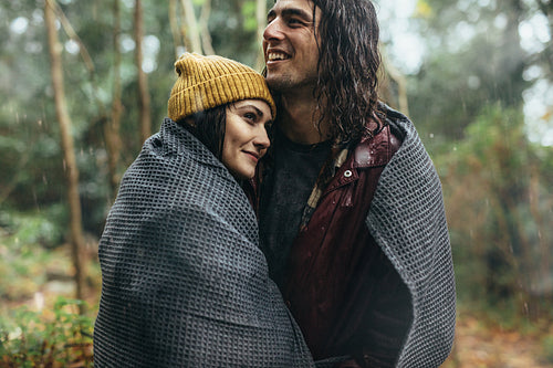 Romantic couple embracing under the rain