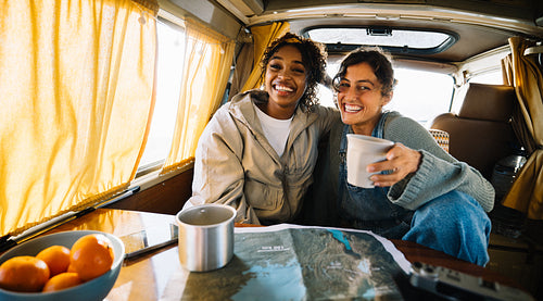 Friends on a road trip in a campervan, smiling together