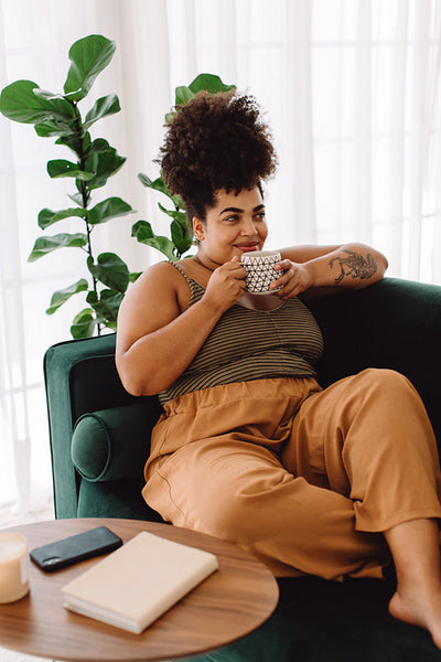 Relaxed woman drinking coffee at home
