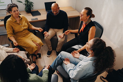 Office team practicing mindful breathing together in a collaborative setting