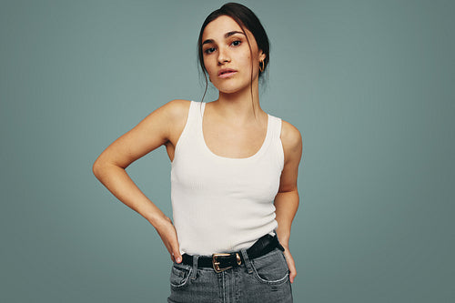 Young woman standing alone in a studio