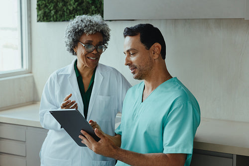 Dental team reviewing patient information on a tablet during clinic consultation