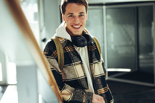 Young man smiling at camera at college staircase