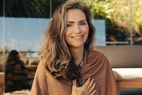 Portrait of a senior woman wearing a crystal necklace at home