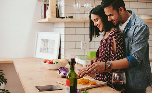 Loving couple cooking in kitchen at home
