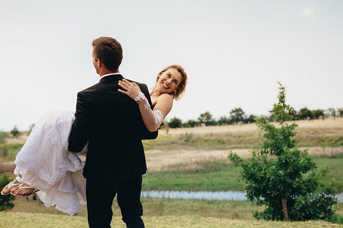 Newly married couple having fun in a park