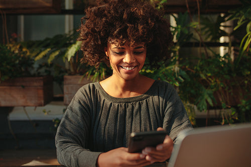 Woman smiling looking at her mobile phone