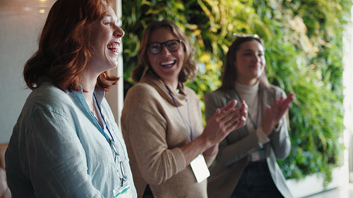 Business women receiving an applause during a business conference