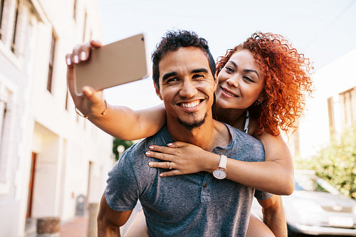 Young couple in a romantic mood having fun in the street.