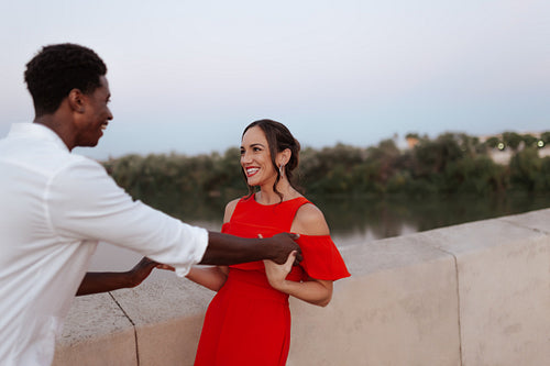 Couple dancing while standing on a bridge