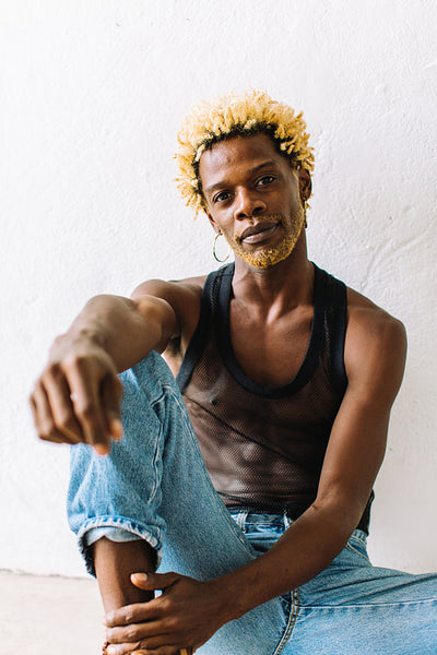 Confident gay man posing alone in a studio