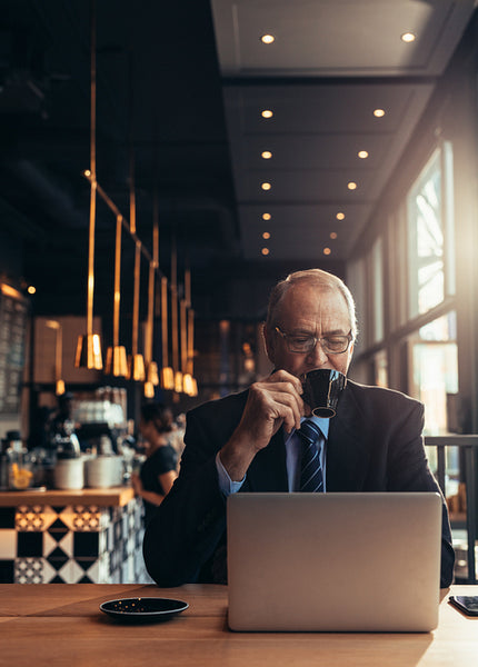 Senior businessman having coffee at cafe