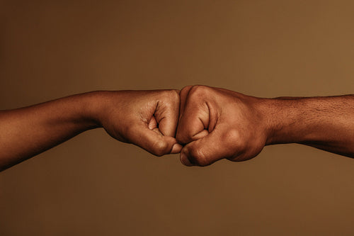 Close up of hands giving fist bump