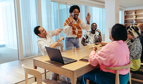 Diverse group of coworkers celebrating with enthusiasm and camaraderie