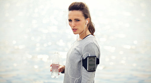 Tired Female Runner with Bottled Water